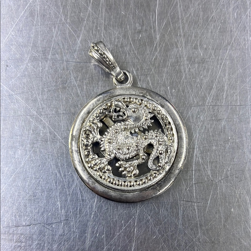Stainless steel pendant with spinning Chinese dragon.